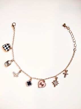 Gold Charm Bracelet with Checkered Heart, Cross, Jewels, Pink Heart with Bow